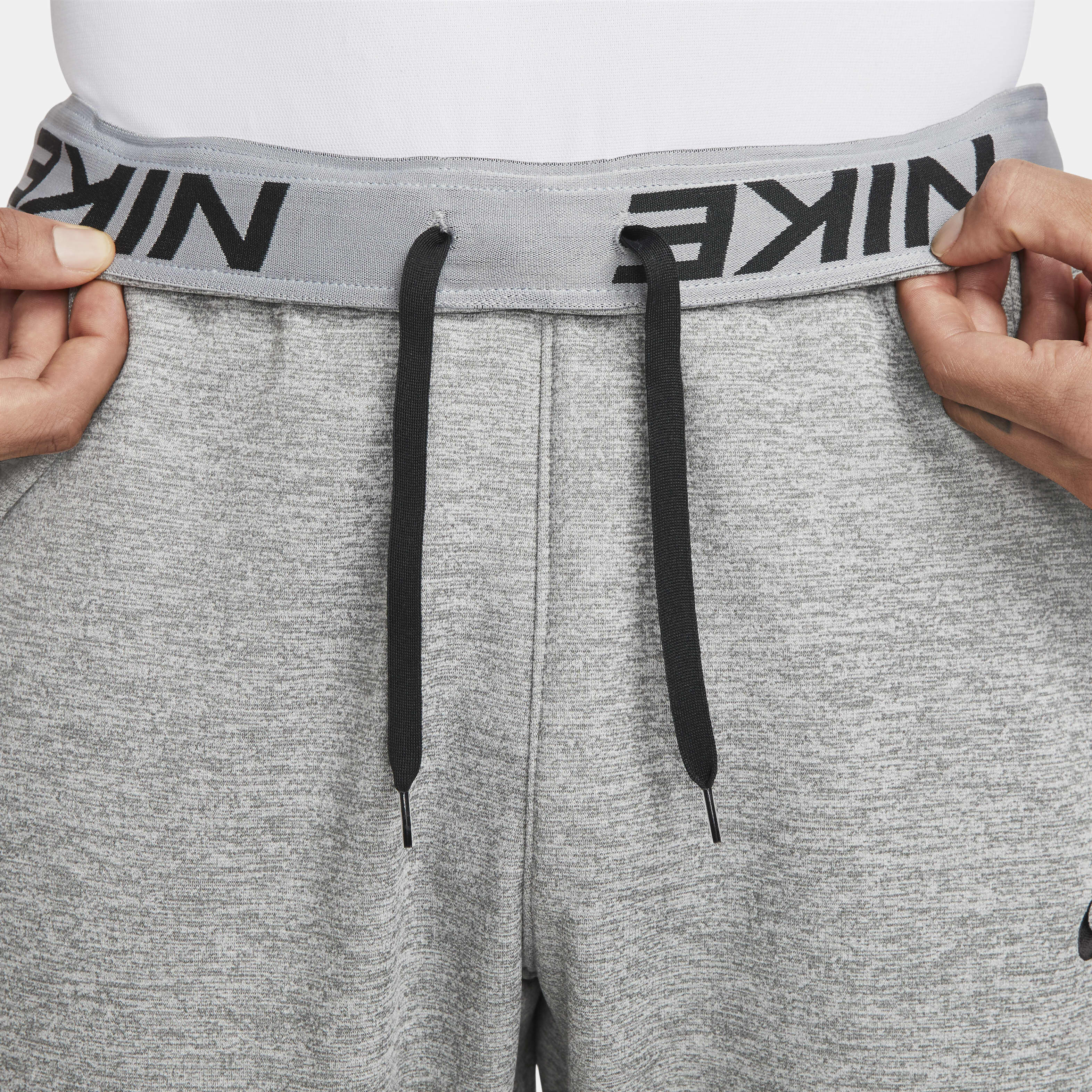 Buy Nike Therma Men s Therma FIT Tapered Fitness Trousers Dark Grey Heather Particle Grey Black Nike Kuwait Official