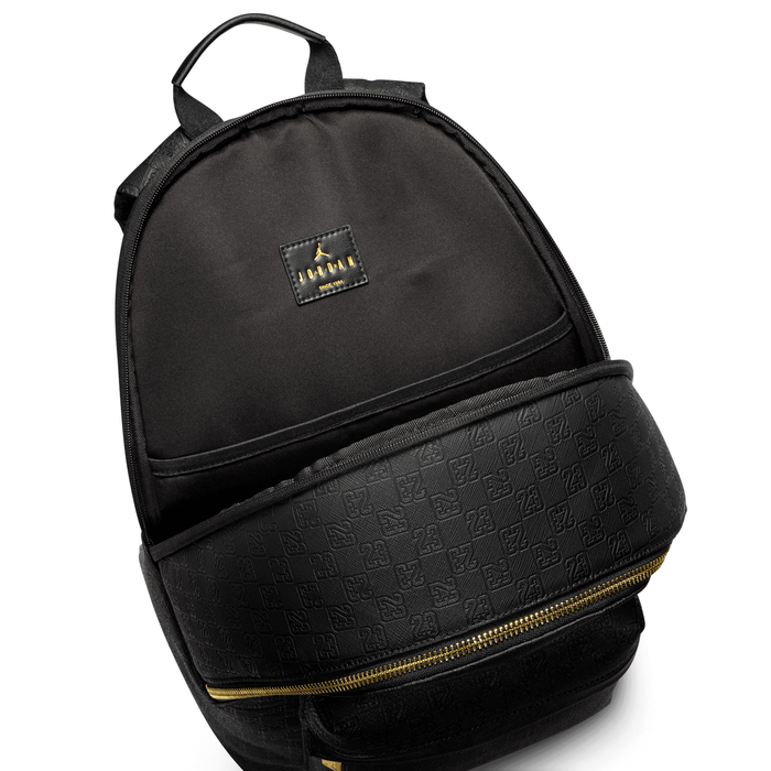 black leather jordan backpack with gold plate on front and Toss items you need quick and easy access to in the front zip pocket Jordan Perforated Backpack (23.5L) -