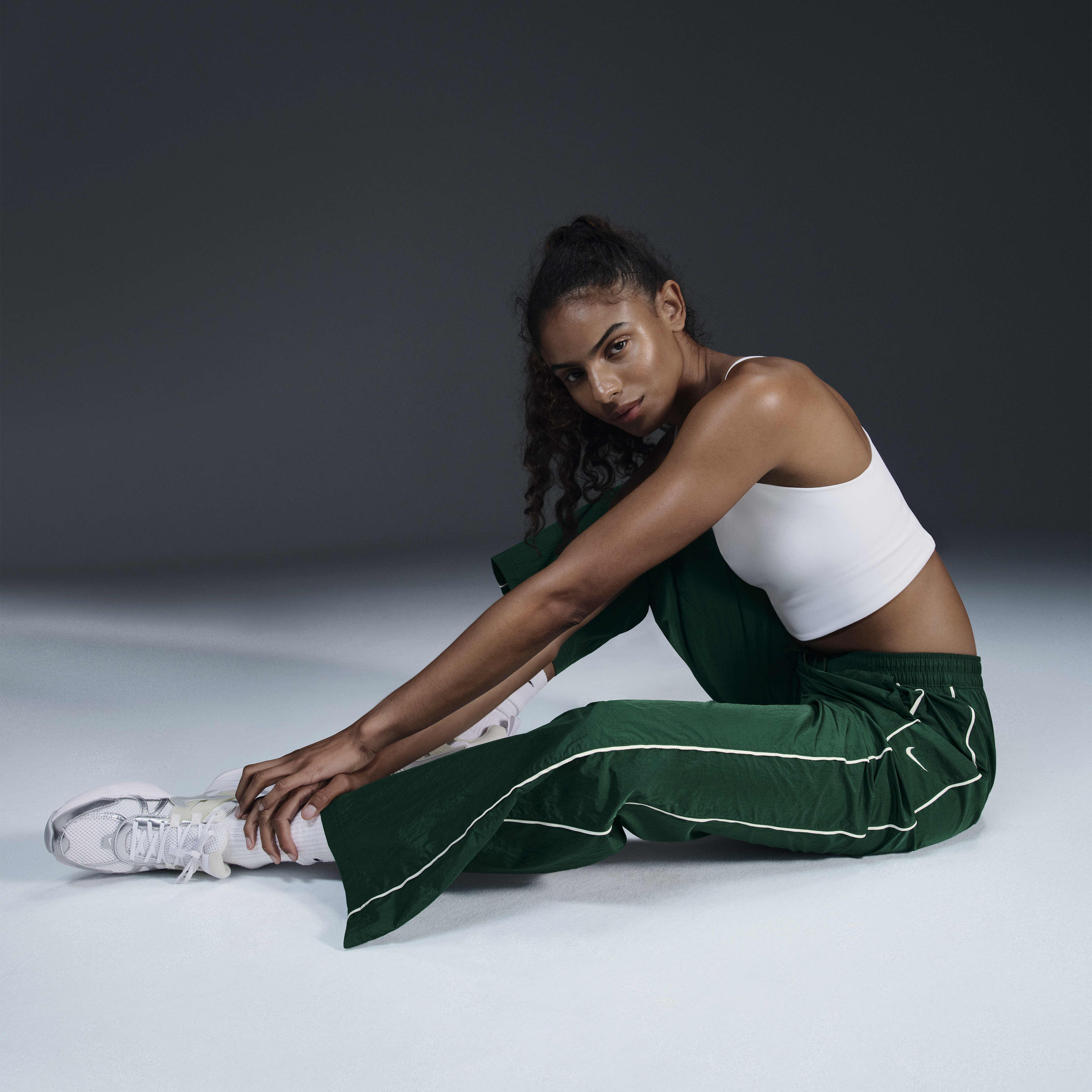 Buy Nike Windrunner Women s High Waisted Woven Open Hem Trousers Gorge Green Sail Nike Kuwait Official