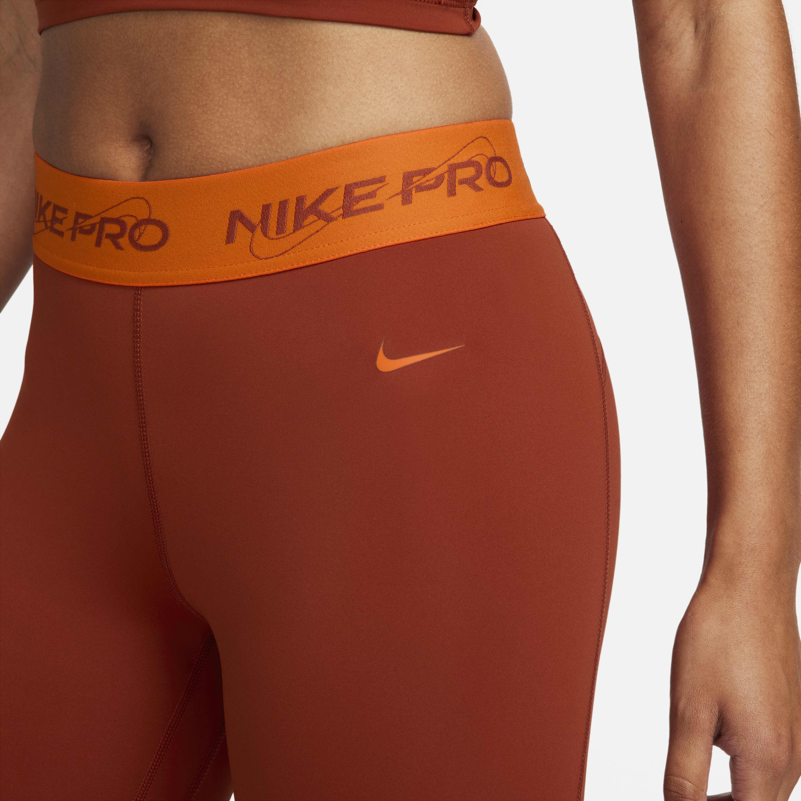 Buy Nike Pro Women s Mid Rise 7 8 Graphic Leggings Rugged Orange Safety Orange Nike Kuwait Official
