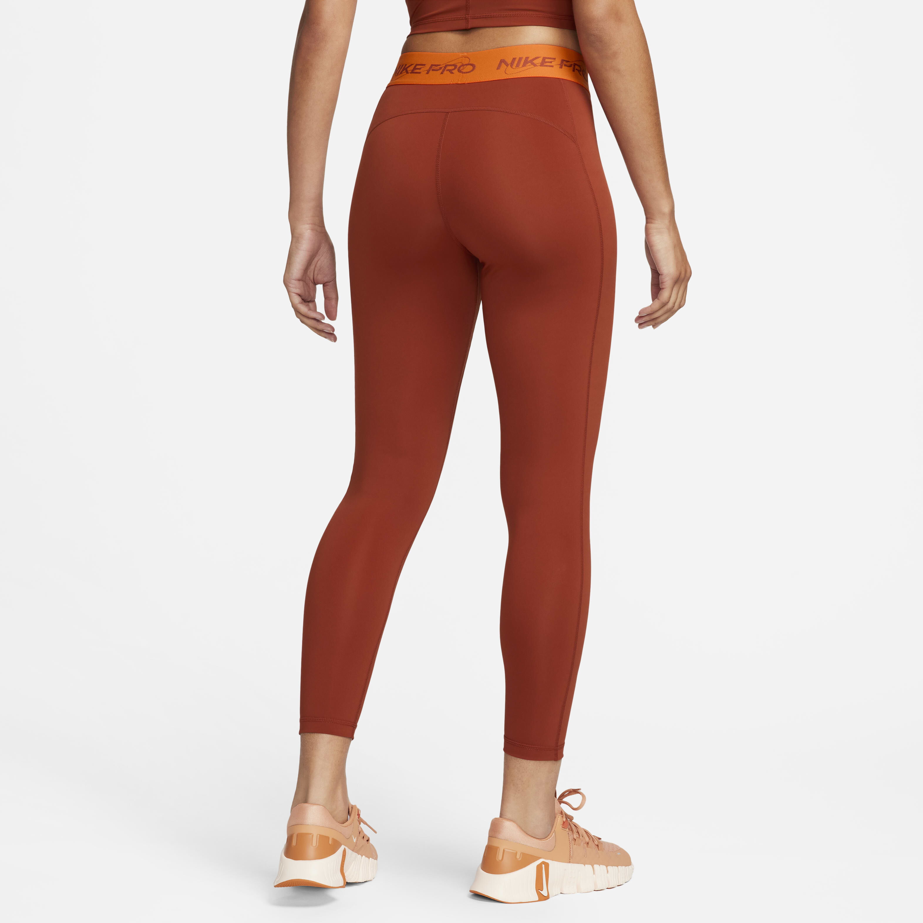 Buy Nike Pro Women s Mid Rise 7 8 Graphic Leggings Rugged Orange Safety Orange Nike Kuwait Official